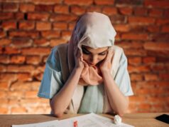 Understanding Wrongful Dismissal: Know Your Employment Rights in Ontario Distressed employee reading a termination letter at a desk, symbolizing the emotional impact of a potential wrongful dismissal