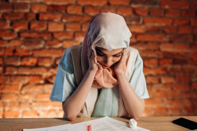 Distressed employee reading a termination letter at a desk, symbolizing the emotional impact of a potential wrongful dismissal